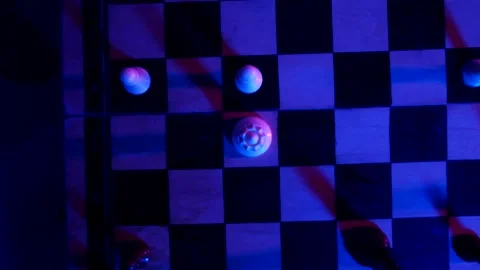 A young man plays chess with a blue background Vídeo Stock 139499545