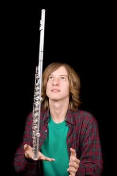 The young man plays with a flute Stock Photos