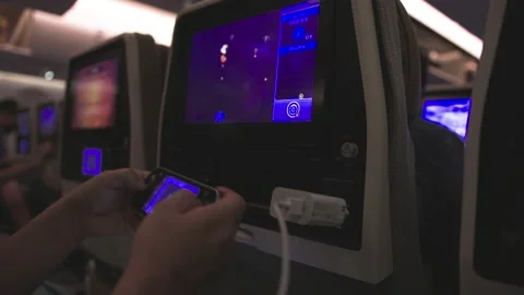 Young Man plays Game during Flight in Airplane. Stock Footage 235280595