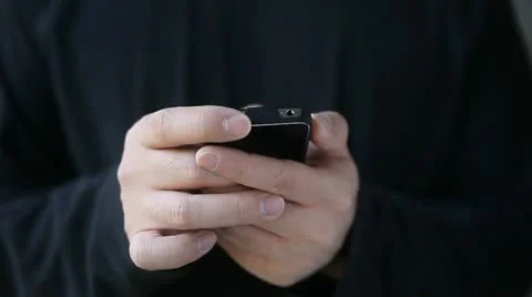 Young man plays game on smart phone Stock Footage 11289184