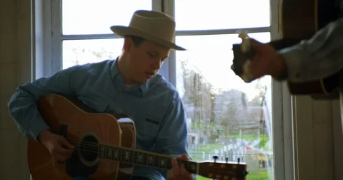 Young man plays guitar and sings. Stock Footage 88375384