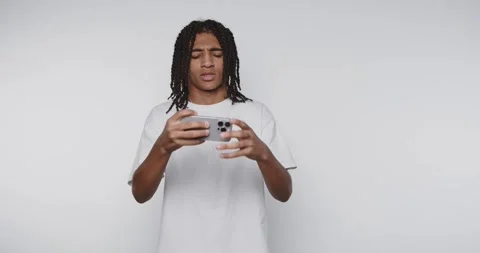 Young man plays mobile game and reacts to different events while focusing o.. Stock-Footage 328248580