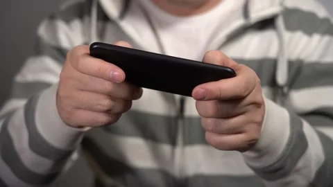 Young Man Plays On The Phone At Work. Video stock 159977588