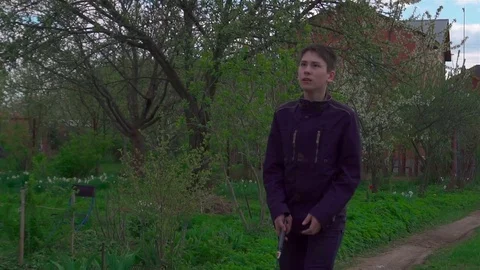 A young man plays with a racket and a shuttlecock in badminton. Slow-mo Stock Footage 75920973