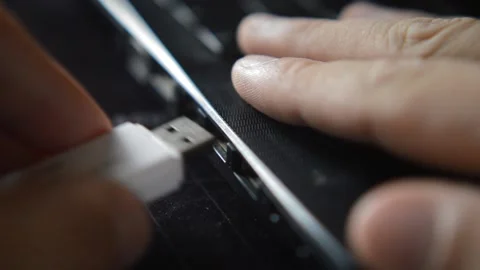 Young man plug white usb data center storage drive on his laptop Video stock 198829253