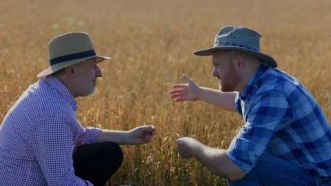 Young man pointing away while sitting on haunches Stock Footage 249696722