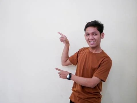Young Man Pointing In Blank Space Stock Photos
