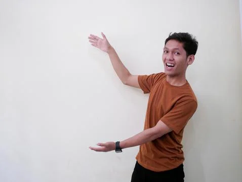 Young Man Pointing In Blank Space Stock Photos