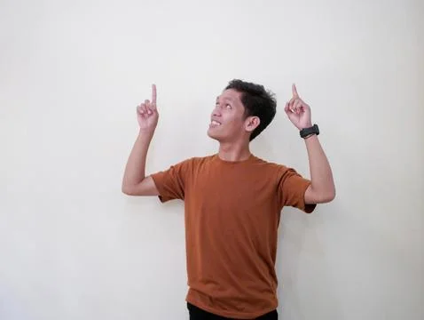 Young Man Pointing In Blank Space Stock Photos