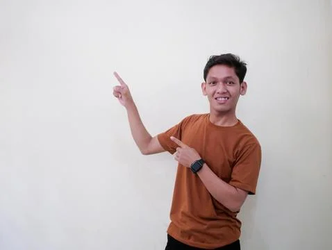 Young Man Pointing In Blank Space Stock Photos