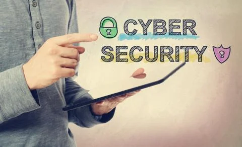 Young man pointing at Cyber Security text over tablet computer Foto stock