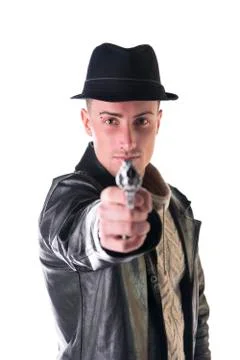 Young man pointing gun at camera, wearing hat and leather jacket Stock Photos