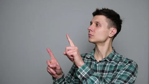 Young man pointing left side, copy space or advertising. Stock Footage 297005927
