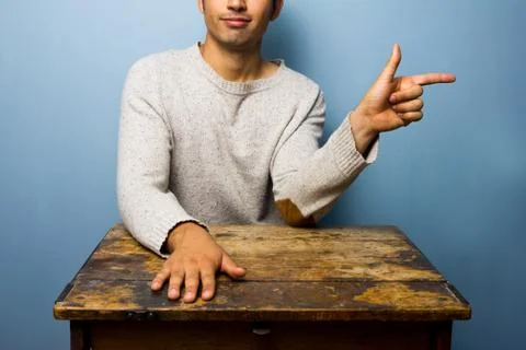 Young man pointing right Stock Photos