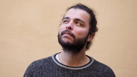 Young man pondering a decision Stock Footage 320255879