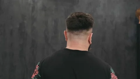 Young man posing after cutting and hairstyling in hair salon. Close up Stock Footage 132556739