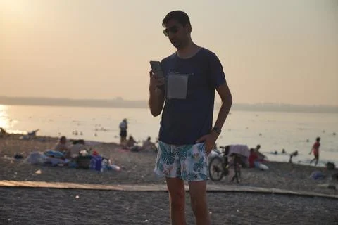 Young man posing on the beach Stock Photos