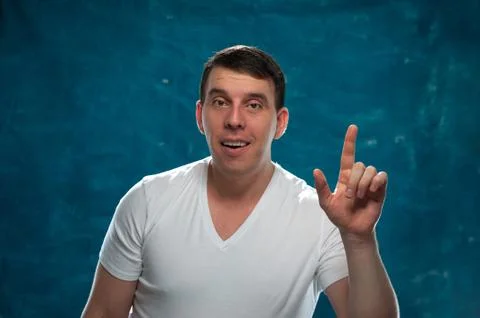 Young man posing on blue background Stock Photos