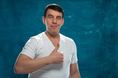 Young man posing on blue background Stock Photos