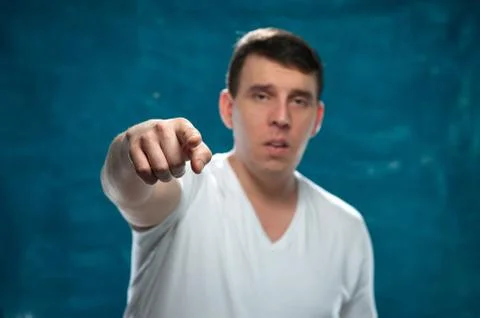 Young man posing on blue background Stock Photos