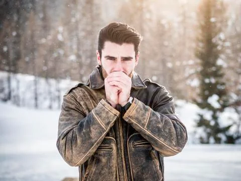 Young man posing at camera in snows Stock Photos