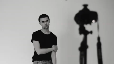 Young man posing for the camera in the studio Stock Footage 68408484