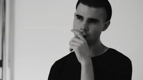 Young man posing for the camera in the studio Stock-Footage 68408828