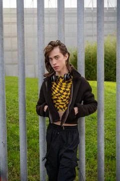 Young man posing with his hands in his pockets and wireless headphones on his Stock Photos