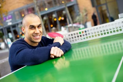 Young man posing holding a table tennis racket Stock Photos