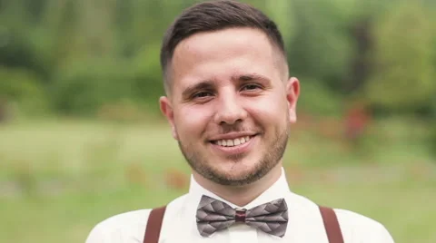 Young man posing outdoor. Portrait of young man in suit r with natural light Stock Footage 66350231
