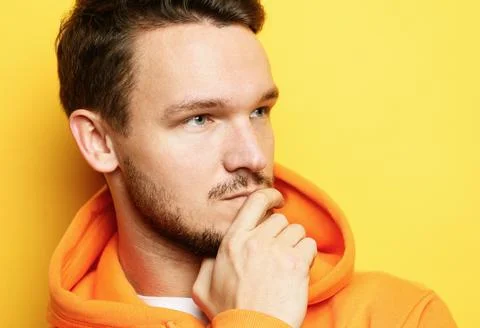 Young man posing over yellow background Stock Photos