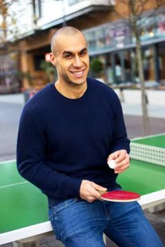 Young man posing with a ping pong racket and ball Stock Photos