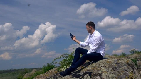 Young man posing for a selfie on a rock Video stock 108114675