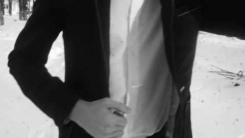 Young man posing in a tuxedo in the winter against the white snow,shot in retro Stock Footage 85070465