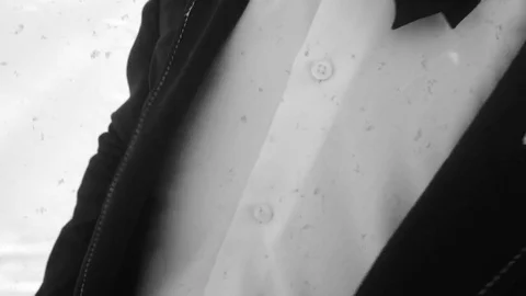 Young man posing in a tuxedo in the winter against the white snow,shot in retro Stock Footage 85070711