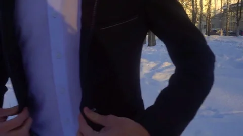Young man posing in a tuxedo in the winter against the white snow Video stock 85137090