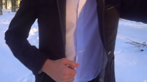 Young man posing in a tuxedo in the winter against the white snow Stock Footage 85137635