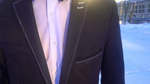 Young man posing in a tuxedo in the winter against the white snow,shot in retro Stock Footage 85140793