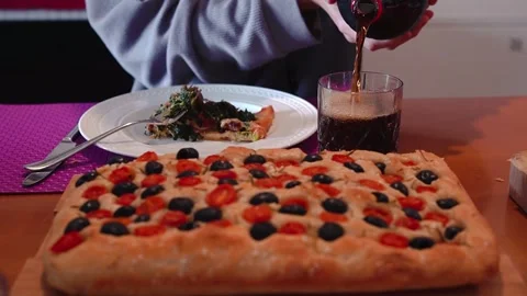 Young Man Pouring Refreshing Drink with Homemade Italian Focaccia Stock Footage 329442508