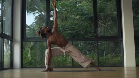 Young man practice triangle and warrior yoga pose at sunrise rapid slow motion Stock Footage 89718155