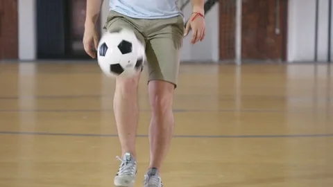 Young man practices with soccer ball Stock Footage 79239063