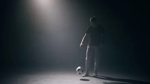 Young man practices with soccer ball Stock Footage 83565034