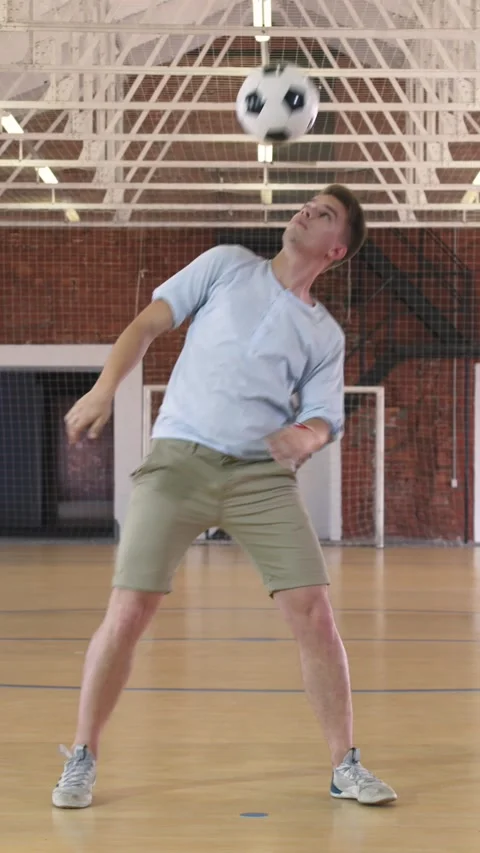 Young man practices with soccer ball Stock Footage 224443393