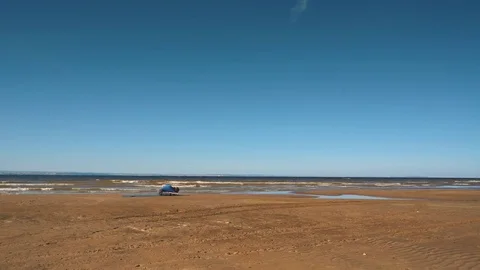 A young man practices yoga on the beach,stretching Stock Footage 80794053