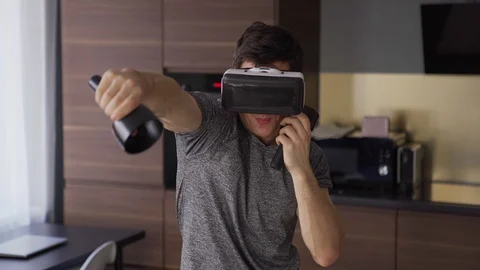 Young man practicing boxing in vr headset Video stock 128757804
