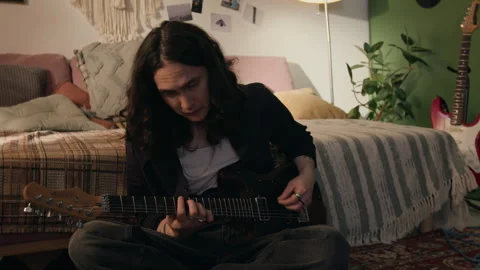 Young Man Practicing Electric Guitar Sitting on Floor in Bedroom Stock Footage 338066283
