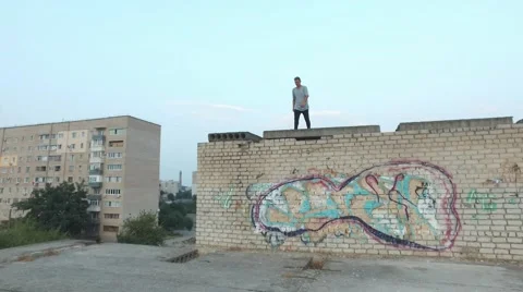 Young man practicing flips and jumps at the roof of building Stock Footage 67315440