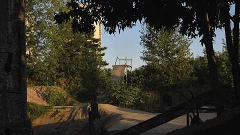 A young man practicing freestyle BMX in BMX park at dusk Stock-Footage 94965619