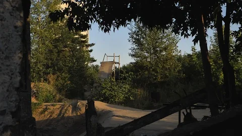 A young man practicing freestyle BMX in BMX park at dusk Stock-Footage 94965636