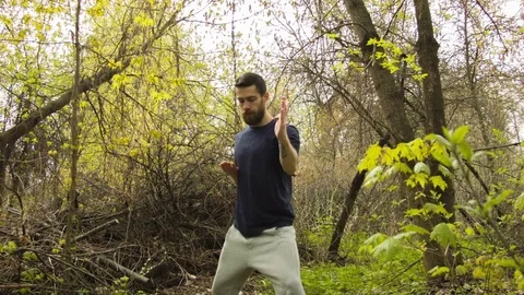 Young man practicing karate in the spring forest. 動画素材 80652458